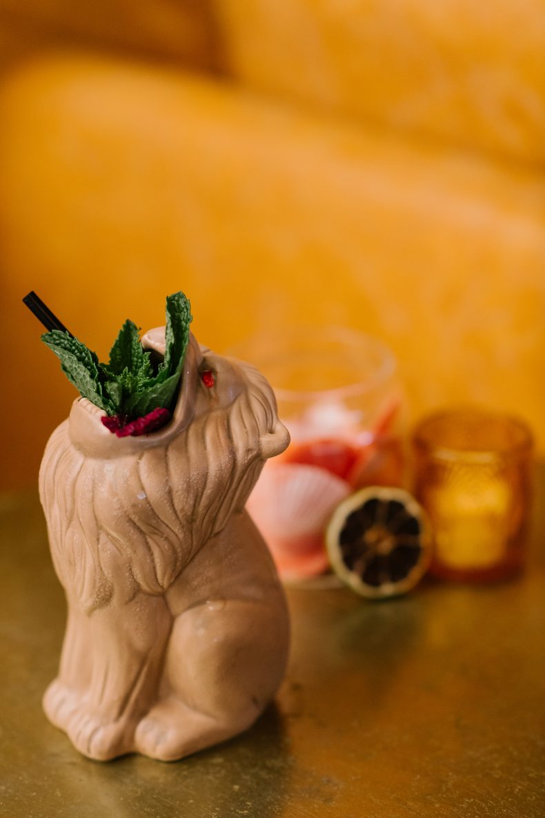 Cocktail in a lion-shaped ceramic mug